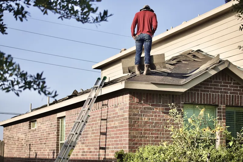 Professional roofer working on a residential roof in Sherwood Knoll